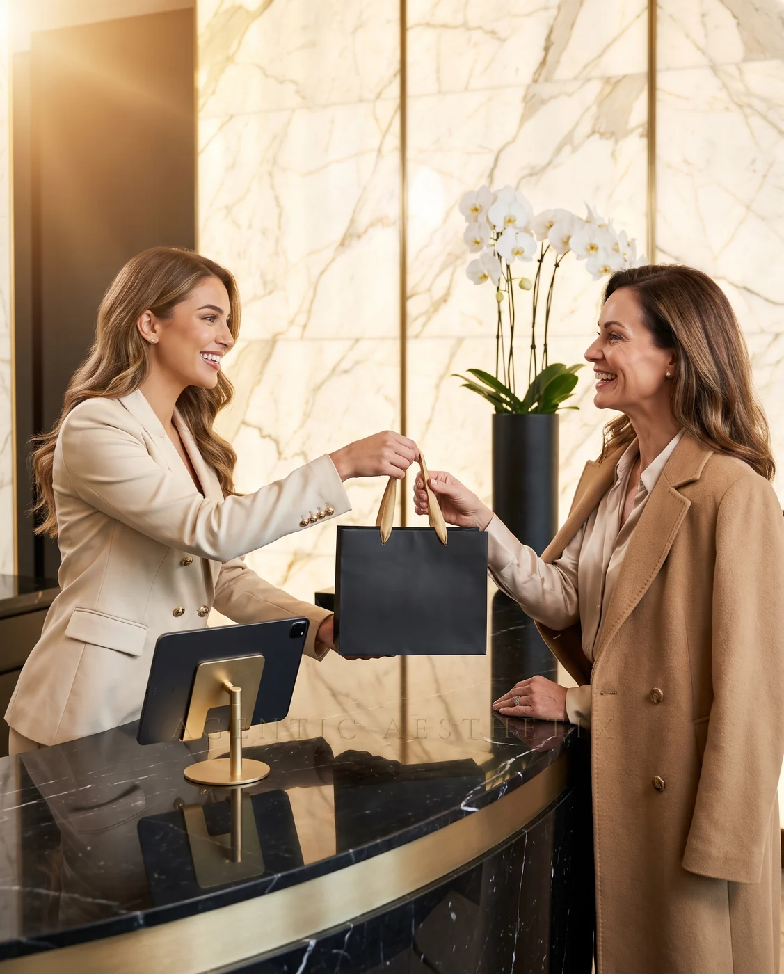 Luxury medspa reception, staff handing premium gift bag to patient at marble and gold reception desk with orchids